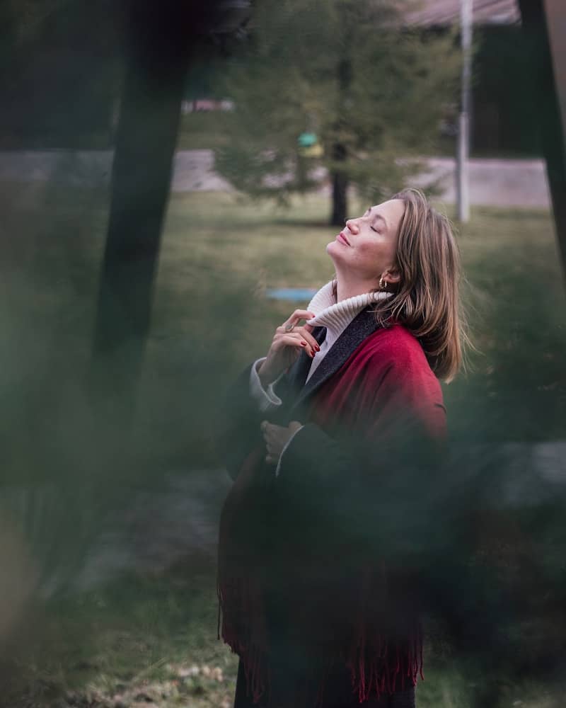 A woman enjoys the sun in nature.