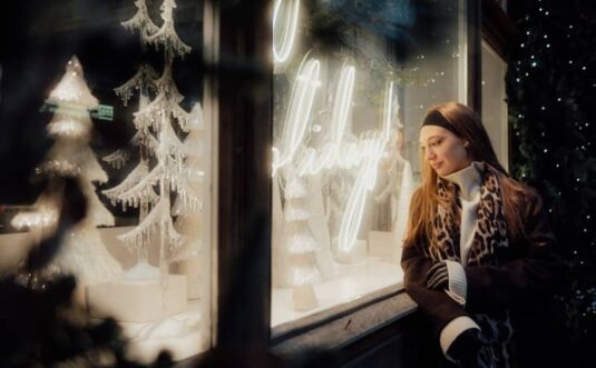 Woman looking at a festive shop window display