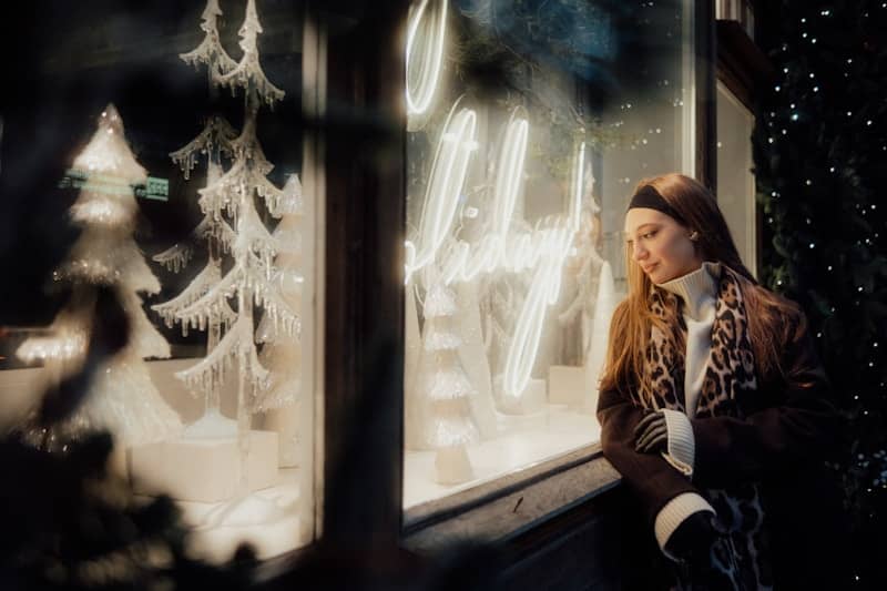 Woman looking at a festive shop window display