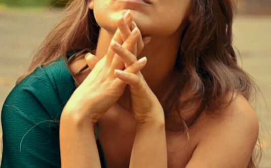 A woman looks upward, deep in thought.